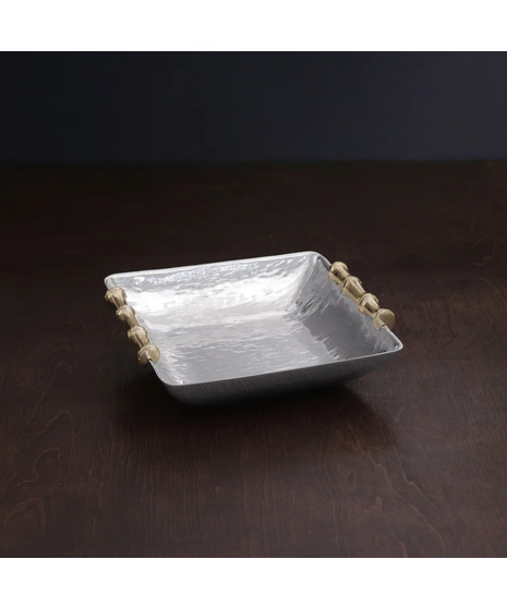 silver serving tray with gold-toned bamboo handles