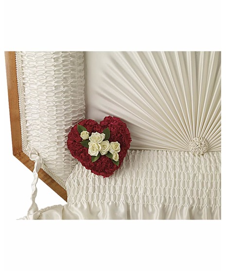 Casket lid corner adornment of red and white flowers.