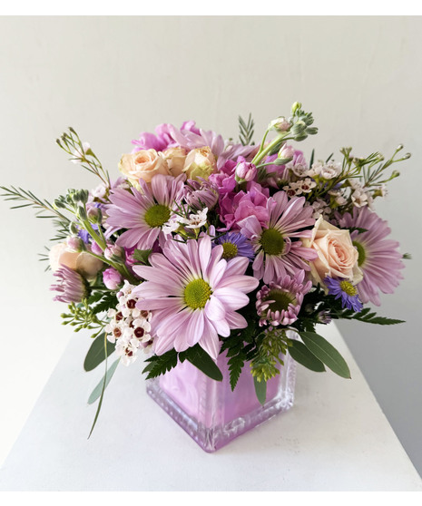 White and pink flowers in a keepsake baby's block vase.