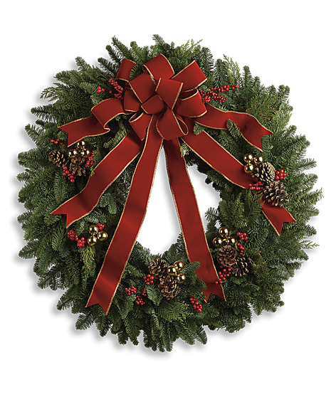 Evergreen wreath of assorted pine and fir branches, berries, pine cones and ribbon.