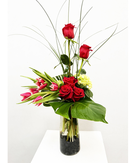 red roses and tulips in dramatic tropical flower arrangement