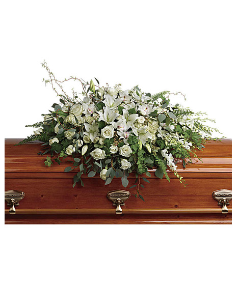 White casket spray made of seasonal flowers. 