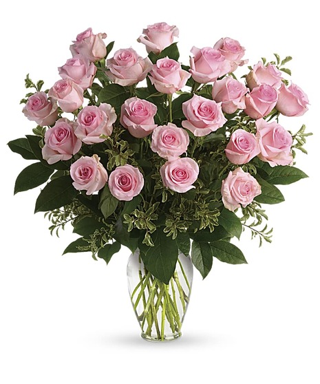One dozen pink roses in a clear glass vase. 