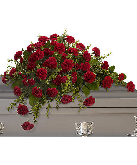 Casket spray of red carnations and greenery. 