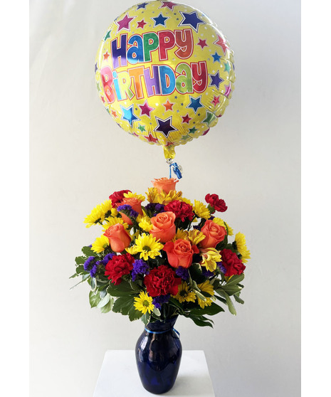 Carnations, roses and more with a happy birthday mylar balloon.